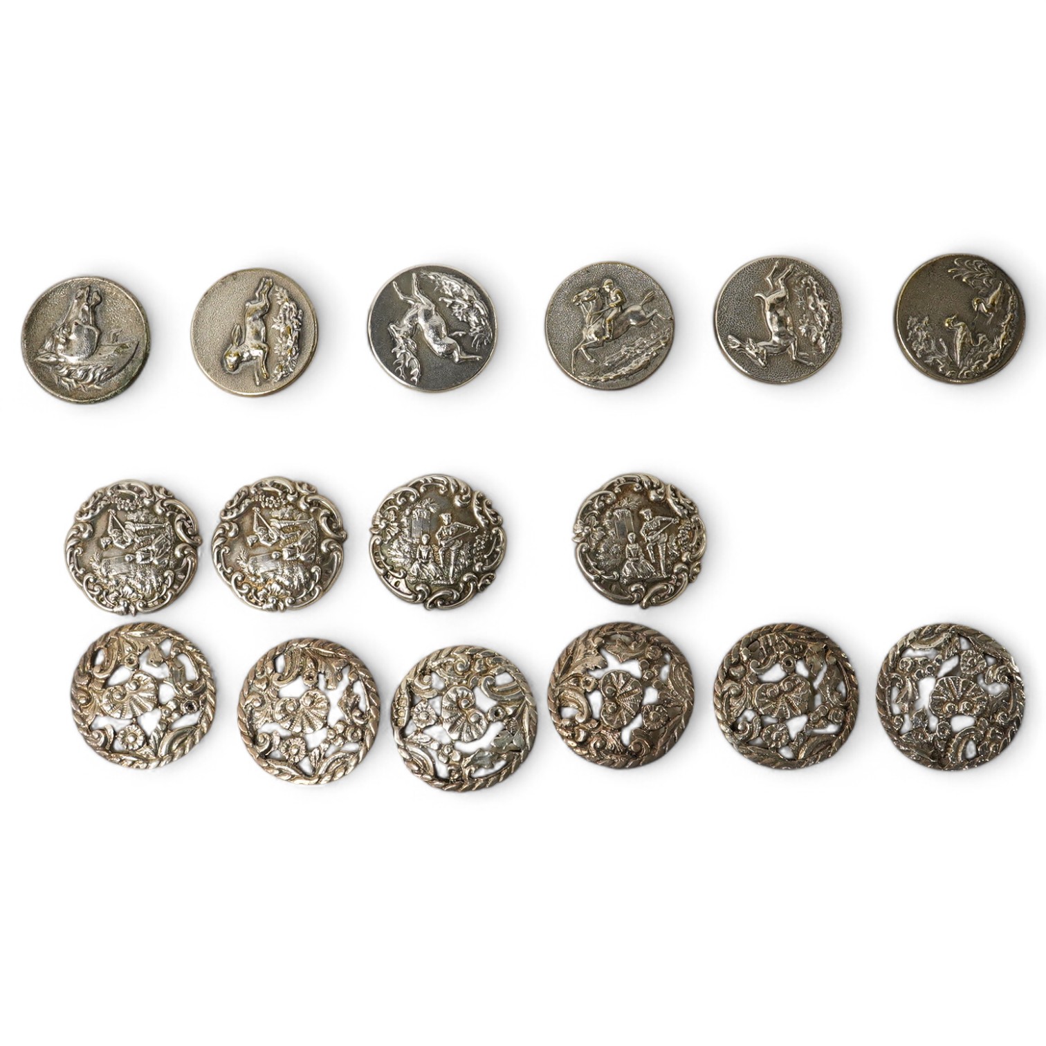 A set of 4 Edwardian cast silver buttons, decorated with a lady and gallant, Levi & Salaman, Birmingham 1901, 27mm, a set of 6 unmarked cast metal buttons decorated with flowers, 30mm and a set of 6 French Perfectionne w